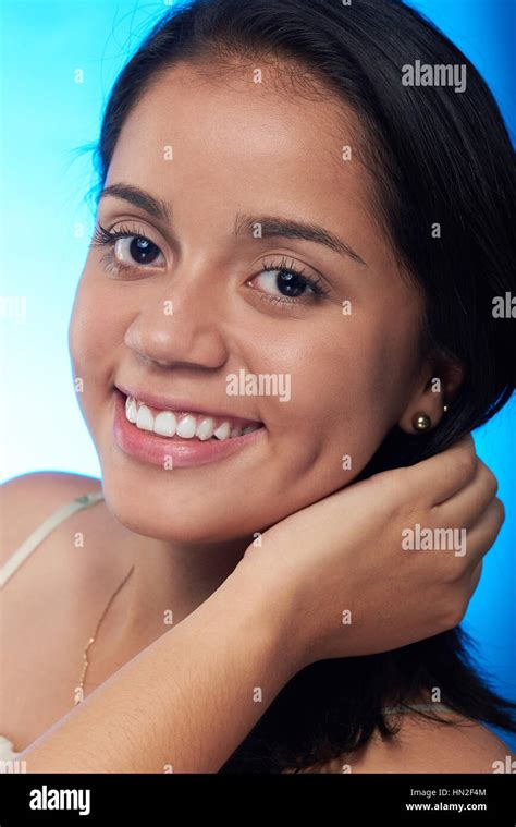 Headshot Of Pretty Hispanic Girl Isolated On Blue Background Stock