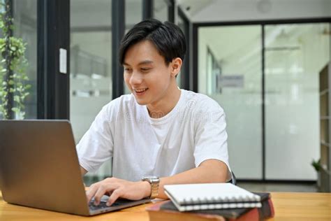 Smart Asian Male Office Worker Or Tech Engineer Working At His Desk