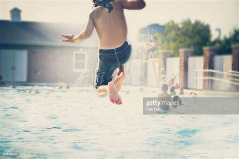 Boy Jumping Into The Pool High Res Stock Photo Getty Images