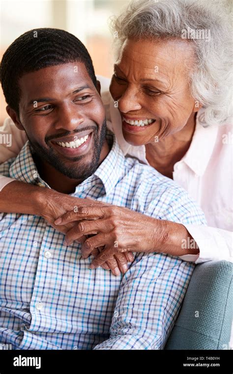 Smiling Senior Mother Hugging Adult Son At Home Stock Photo Alamy