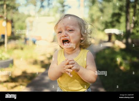 Close Up Portrait Of Little Funny Cute Blonde Girl Child Toddler In