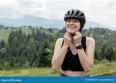 Woman Cyclist Wear Bicycle Helmet To Ride A Bicycle In Mountains Stock