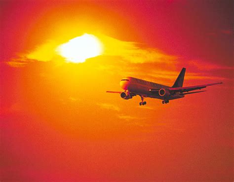 Airplane Flying At Sunset Photograph By Darwin Wiggett