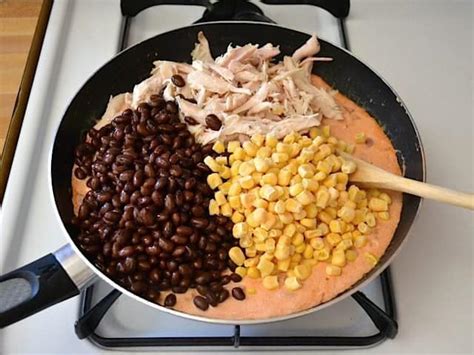 This easy chicken, black bean and tortilla casserole is a hearty, flavorful, healthyish dish that's perfect to celebrate cinco de healthy veggies like tomatoes, black beans, onions, green chiles and corn combined with some shredded rotisserie chicken and then layered. chicken rice black beans corn casserole
