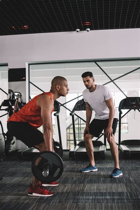 Attentive Trainer Instructing African American Sportsman Stock Image