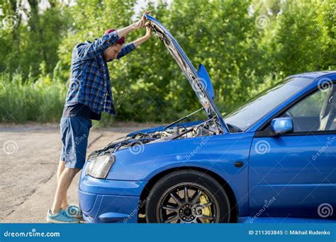 The Sad Disappointed Man Standing Near The Car With Opened Hood Fix