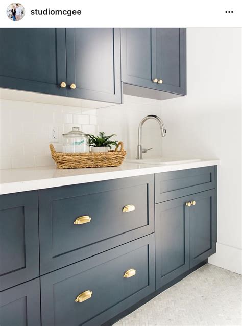 Hale navy on lower kitchen cabinets still looks bright and inviting when paired with the white upper cabinets and warm wood flooring in the project below. hale Navy - Benjamin Moore | Kitchen, Kitchen inspirations, Kitchen remodel