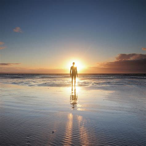Man Walking On Beach At Sunset By Stu Meech