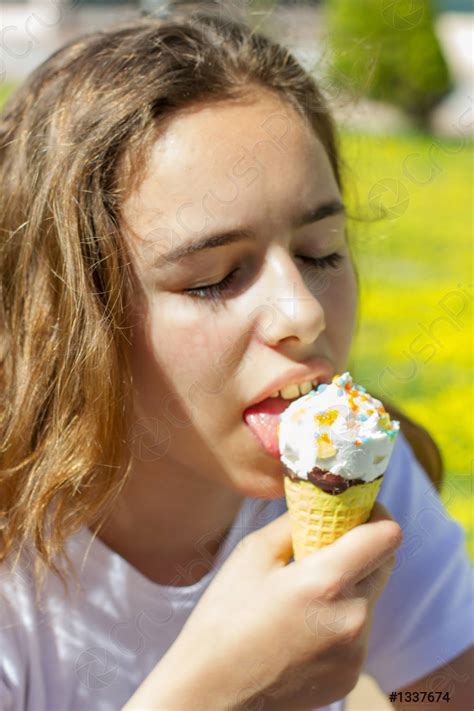 Beautiful Teen Girl Eating Ice Cream In A Waffle Cone Stock Photo Crushpixel