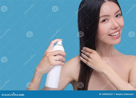 Smiling Woman Spraying New Hairspray On Her Hair Stock Image Image Of Attentive Fashion