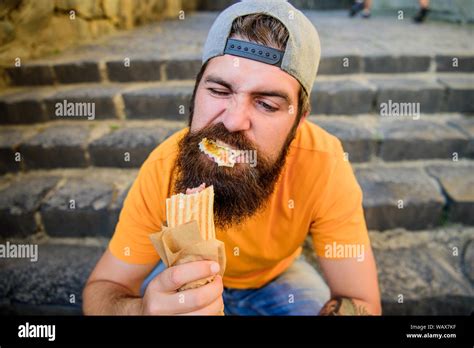 Street Food Concept Man Bearded Eat Tasty Sausage Urban Lifestyle Nutrition Carefree Hipster