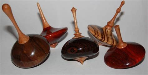Four Wooden Spoons With Different Designs On Them