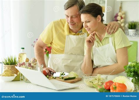 Happy Husband And Wife Cooking Together In The Kitchen Stock Photo Image Of Activity