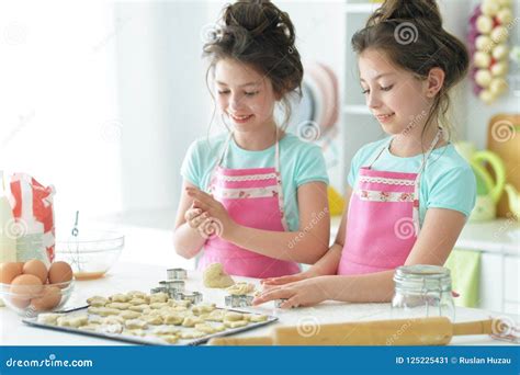 Portrait Of A Two Girls In The Kitchen Stock Image Image Of Happiness Baking 125225431