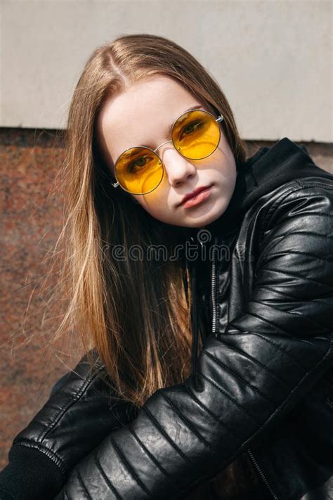 Beautiful Fashionable Kid Girl With Long Hair In Yellow Sunglasses In