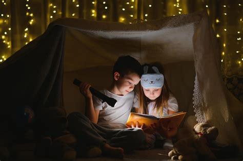 Premium Photo Little Children Reading Bedtime Story At Home