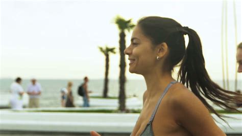 Two Athletic Woman Running Outdoors In Slow Motion On Promenade At
