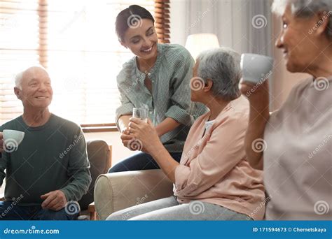 Young Woman Taking Care Of Elderly People In Room Stock Image Image
