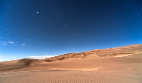 Stars In The Clear Night Sky Over A Sandy Desert In Colorado Free