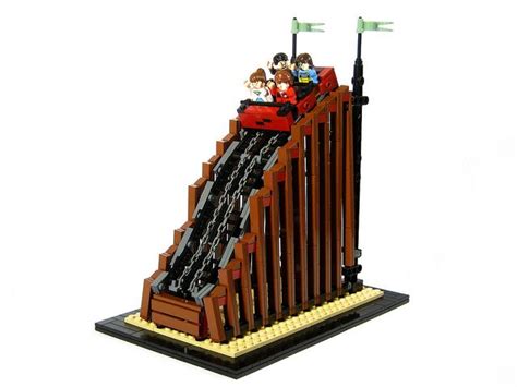 A Lego Model Of A Roller Coaster With People Riding On The Top And Down It