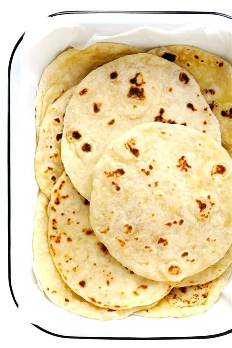 Several Tortillas In A White Dish On Top Of Each Other