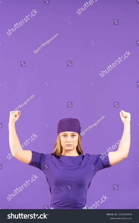 Young Serious Woman Flexing Bicep Muscles Stock Photo 2252958439