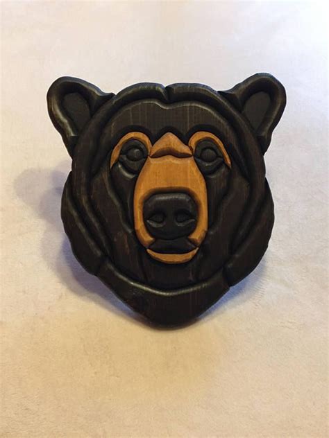 A Brown Bear Head On Top Of A White Countertop Next To A Bottle Opener