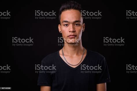 Young Handsome Indian Man Against Black Background Stock Photo