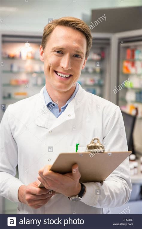Happy Pharmacist Writing On Clipboard Stock Photo Alamy