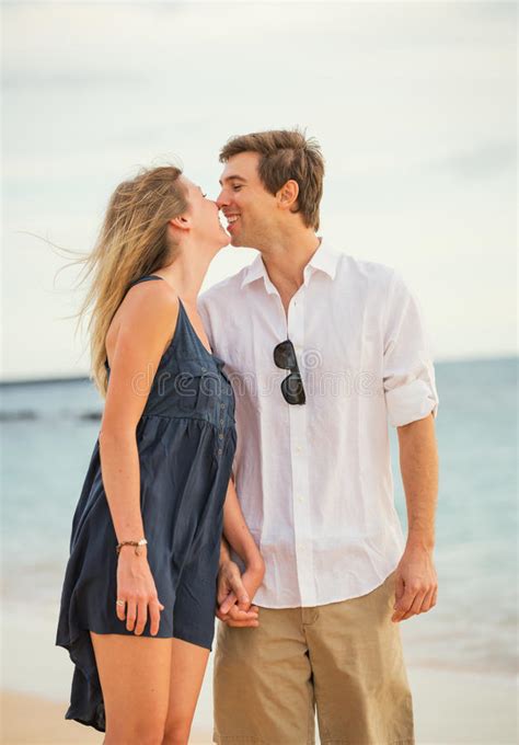 Happy Romantic Couple Kissing On The Beach At Sunset Stock Photo Image