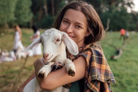 Premium Photo Beautiful Woman With Small Goat In Countryside Have Friendship In Nature