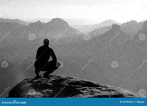 Moment Of Loneliness Man In Shirt Sit On The Cliff Of Rock And
