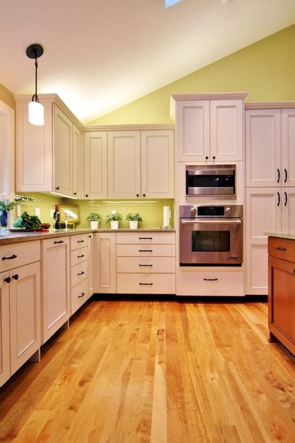 When i remodeled our last kitchen, i had an outlet added up above the cabinets with a switch. Above cabinet lighting - Traditional - Kitchen - Portland - by Designer's Edge Kitchen & Bath