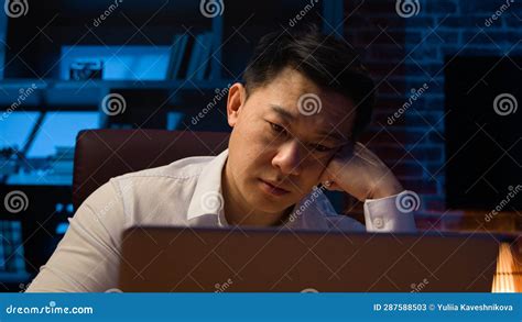 Tired Asian Sleepy Businessman In Night Office Work With Laptop