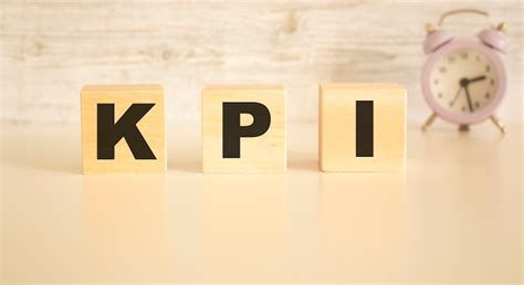 Premium Photo The Word Kpi Consists Of Wooden Cubes With Letters Top