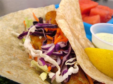 Alaska flounder with lightly seasoned breading on a corn tortilla with melted cheese, citrus slaw and cilantro sauce (318 cals). Love the rainbow of colors on the choice line with the ...