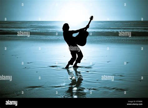 Guitar Player At The Beach At Night Stock Photo Alamy