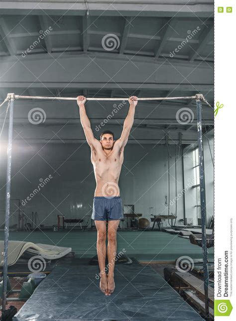Male Gymnast Performing Handstand On Parallel Bars Stock Photo Image