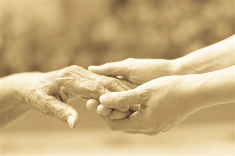 Caregiver Carer Hand Holding Elder Hand In Hospice Care Philanthropy