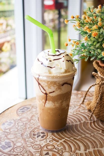 Premium Photo Ice Mocha Frappe Served With Whipping Cream In Plastic Cup