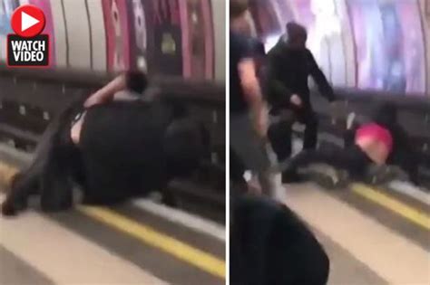 brawling men almost crushed by oncoming tube train in heart stopping footage daily star