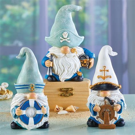 Three Gnome Figurines Sitting Next To Each Other On A Table With A