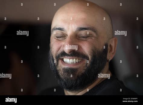 Close Up Portrait Of Bearded Bald Man With Beautiful White Teeth