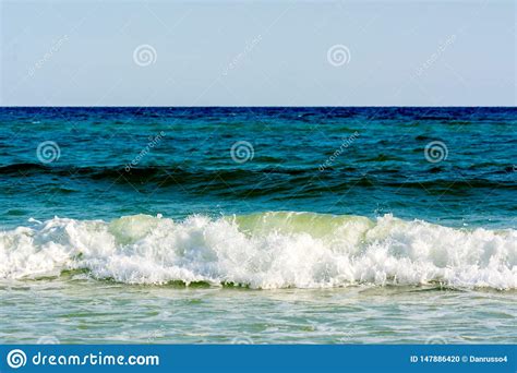Green Ocean Wave On Blur Blue Ocean Water Background Stock Photo