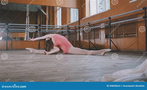 Beautiful Gymnast Does The Splits In A Room With Ballet Lathe And