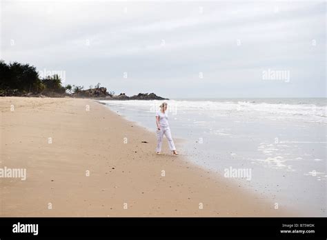 Lady Strolling On The Beach Stock Photo Alamy