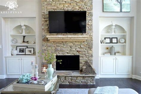 Two Story Living Room With Stacked Stone Fireplace And Built Ins