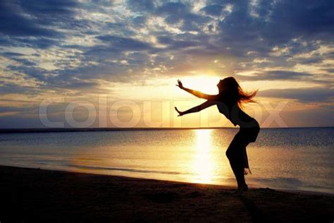 Active Woman Dancing At The Beach During Sunset Stock Photo Colourbox