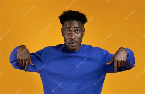 Premium Photo Surprised Young African American Man Pointing Down