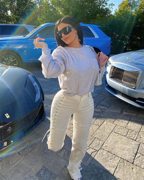 Kylie Jenner Street Style In A Straight Fit White Lace Up Jeans Posing